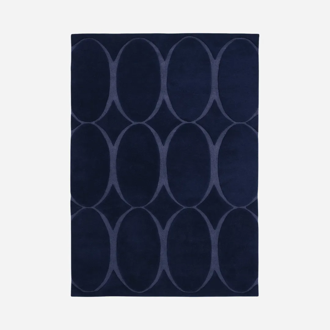 Hand-tufted blue rug with oval eclipse pattern