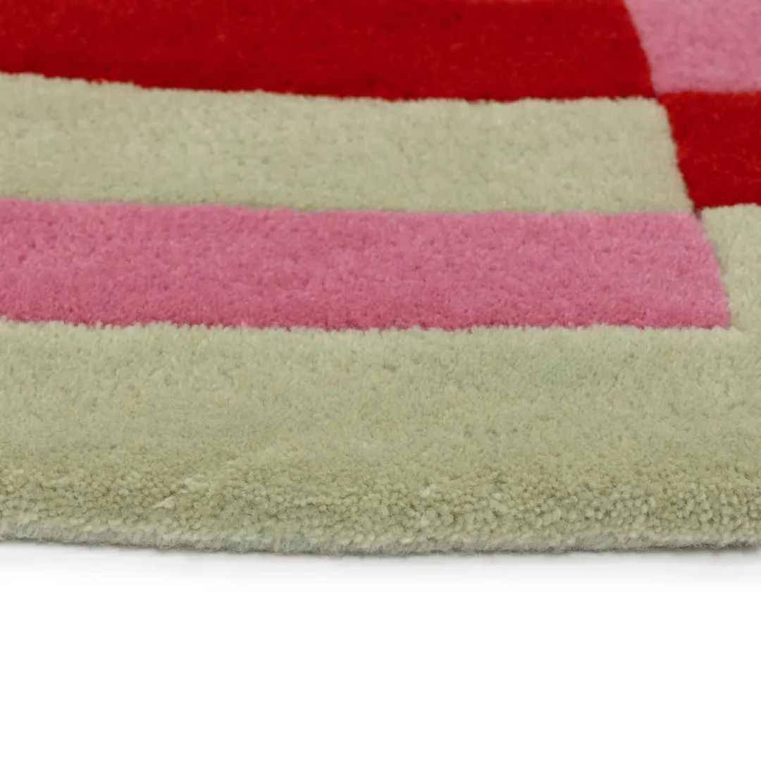 Colorful circular area rug in red, pink, green, and yellow tones