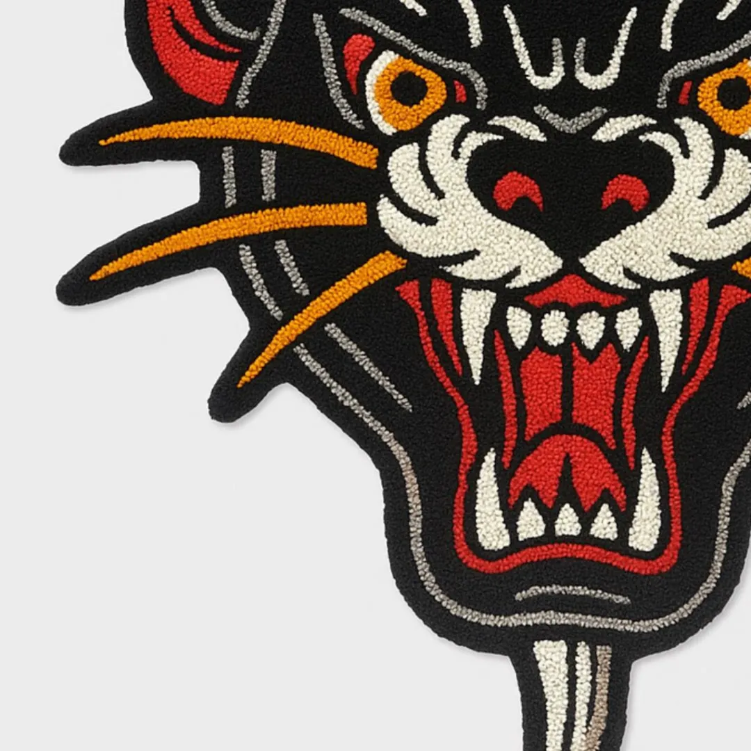 Tattoo-inspired panther rug with sword piercing through head