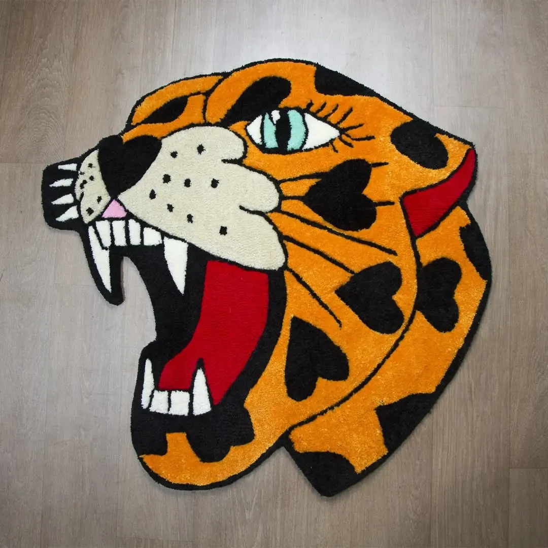 Wild Panther Heart tattoo rug close-up showing detailed jaguar face and heart-shaped spots in vivid orange and black.