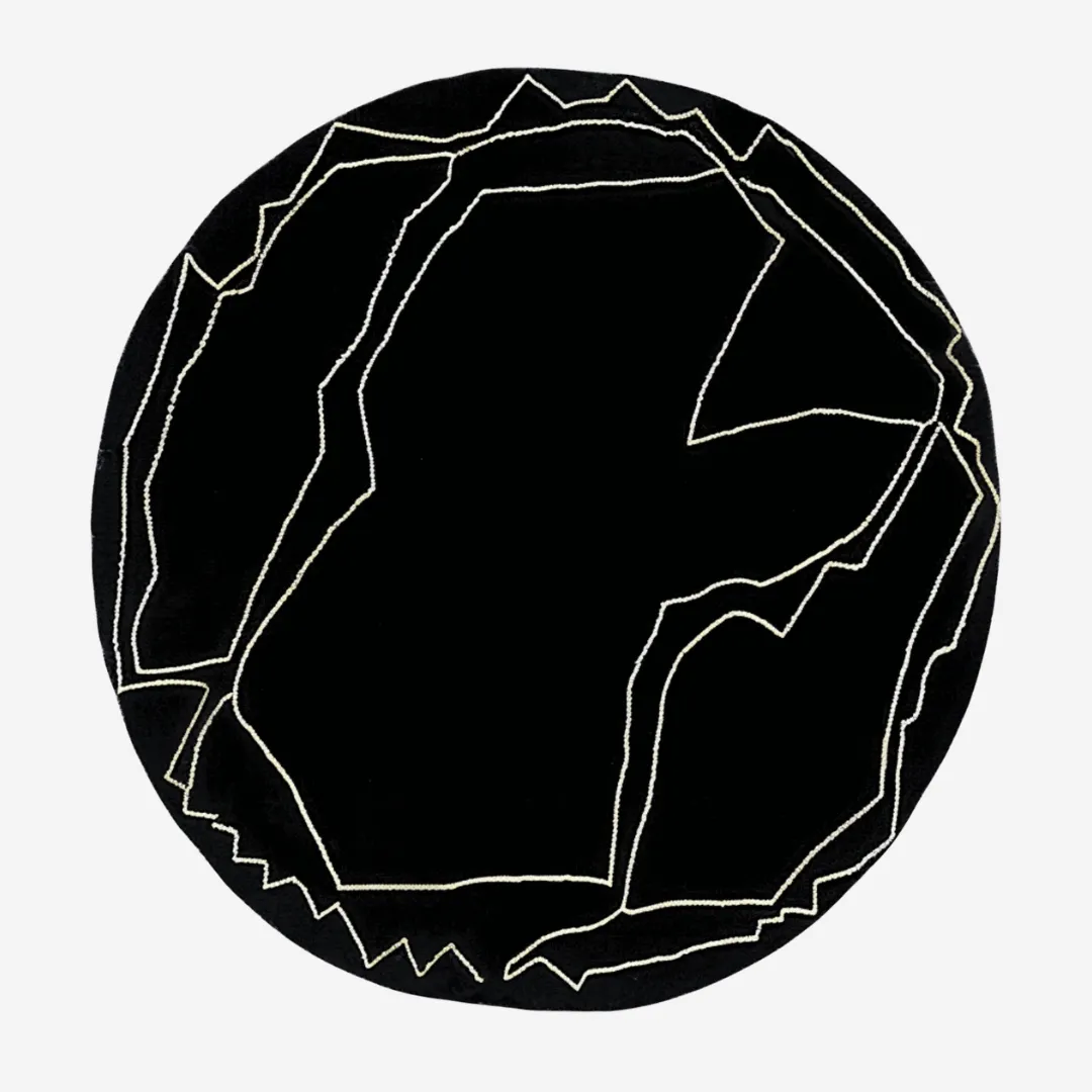 Round black wool rug with abstract white lines
