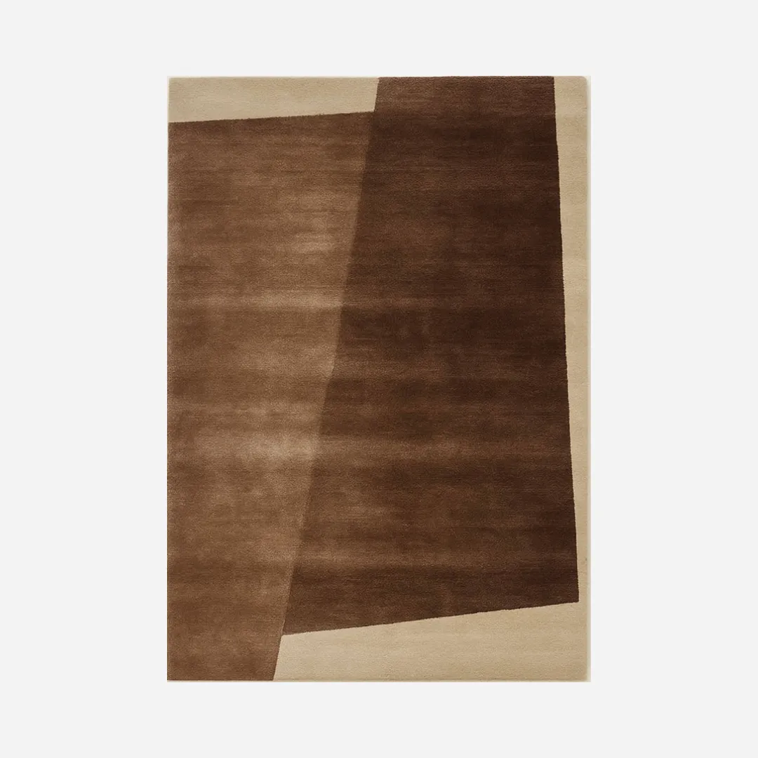 Minimalist brown abstract rug with layered geometric blocks in mocha, chocolate, and beige tones.
