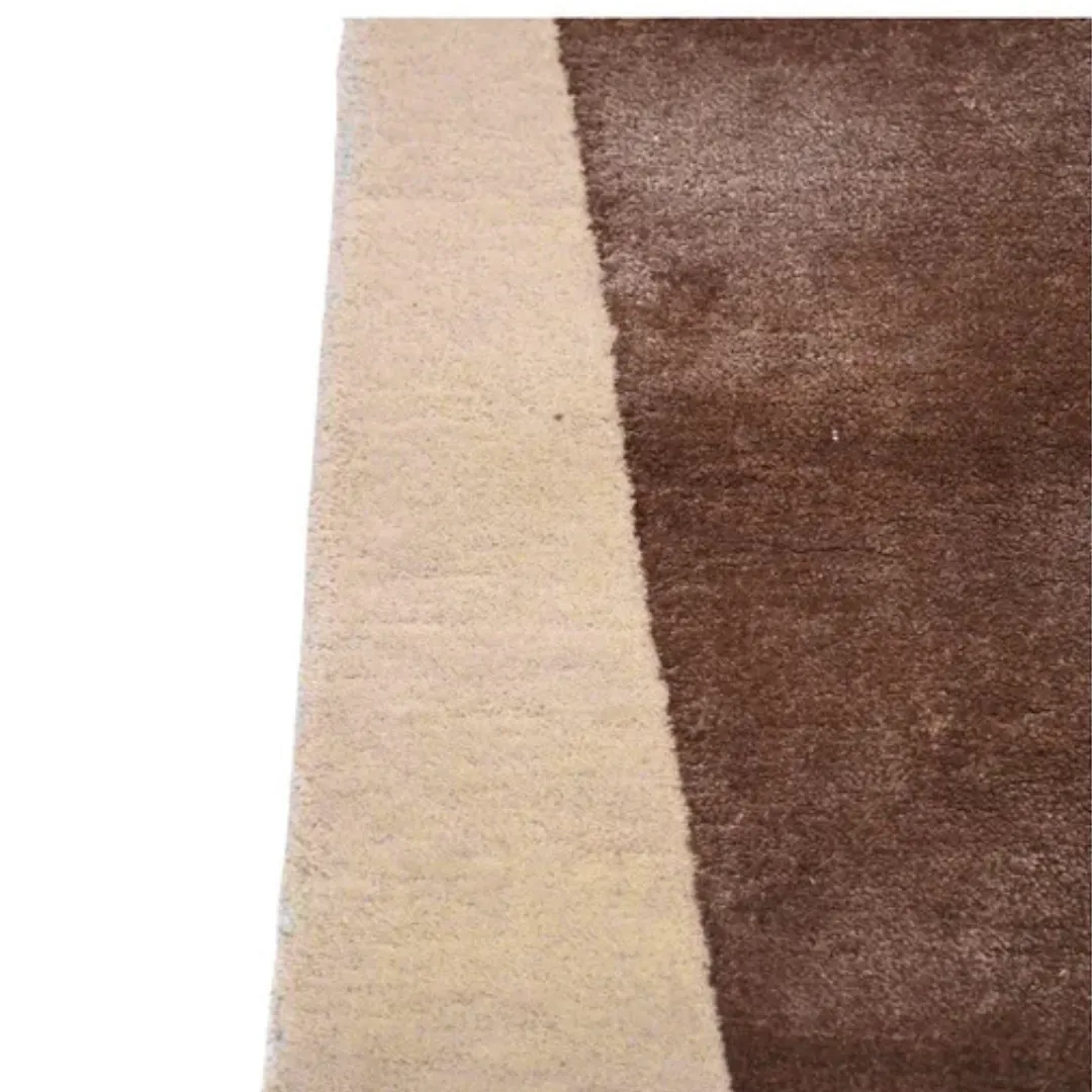 Modern area rug in overlapping shades of brown with clean lines and soft texture.
