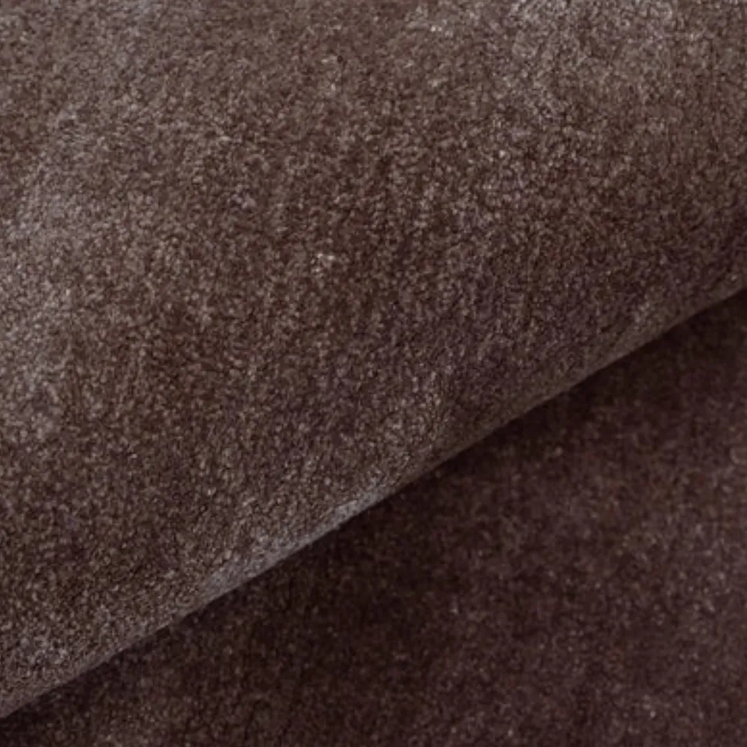 Abstract rectangular rug featuring deep brown and beige color blocks with a soft finish.