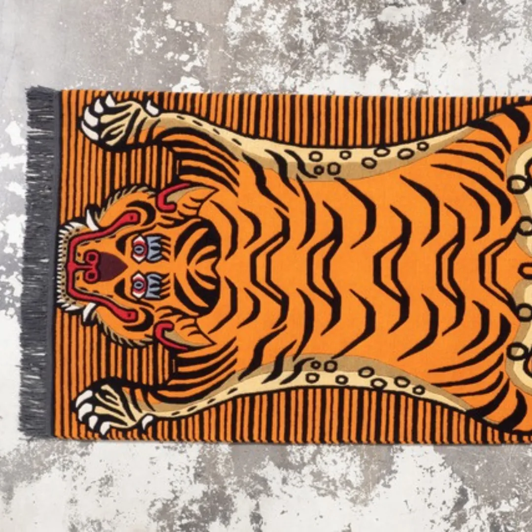 Orange striped Tibetan tiger area rug with animal print design, perfect for bold interiors