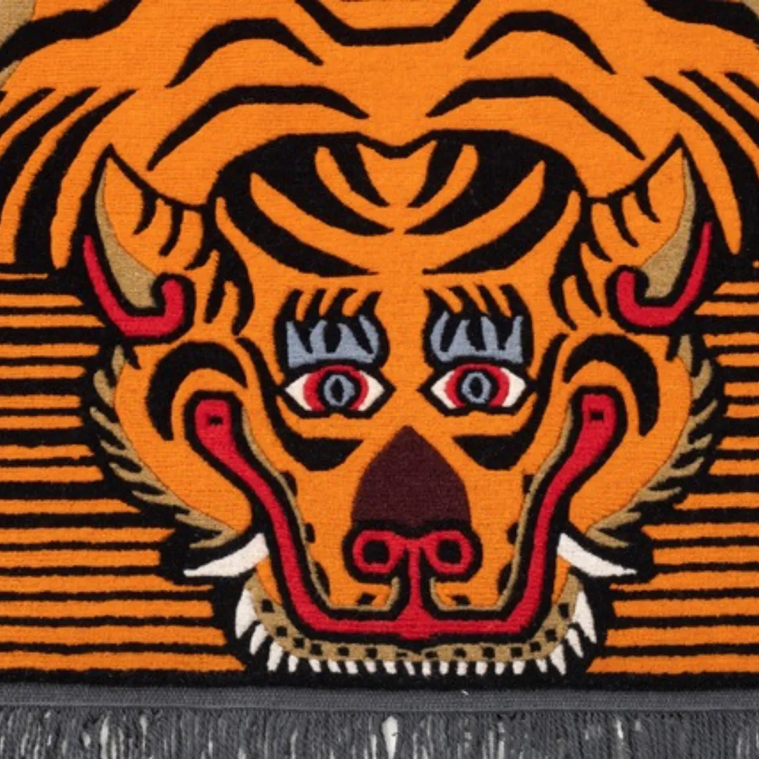 Orange Tibetan tiger rug with black stripes and red eyes