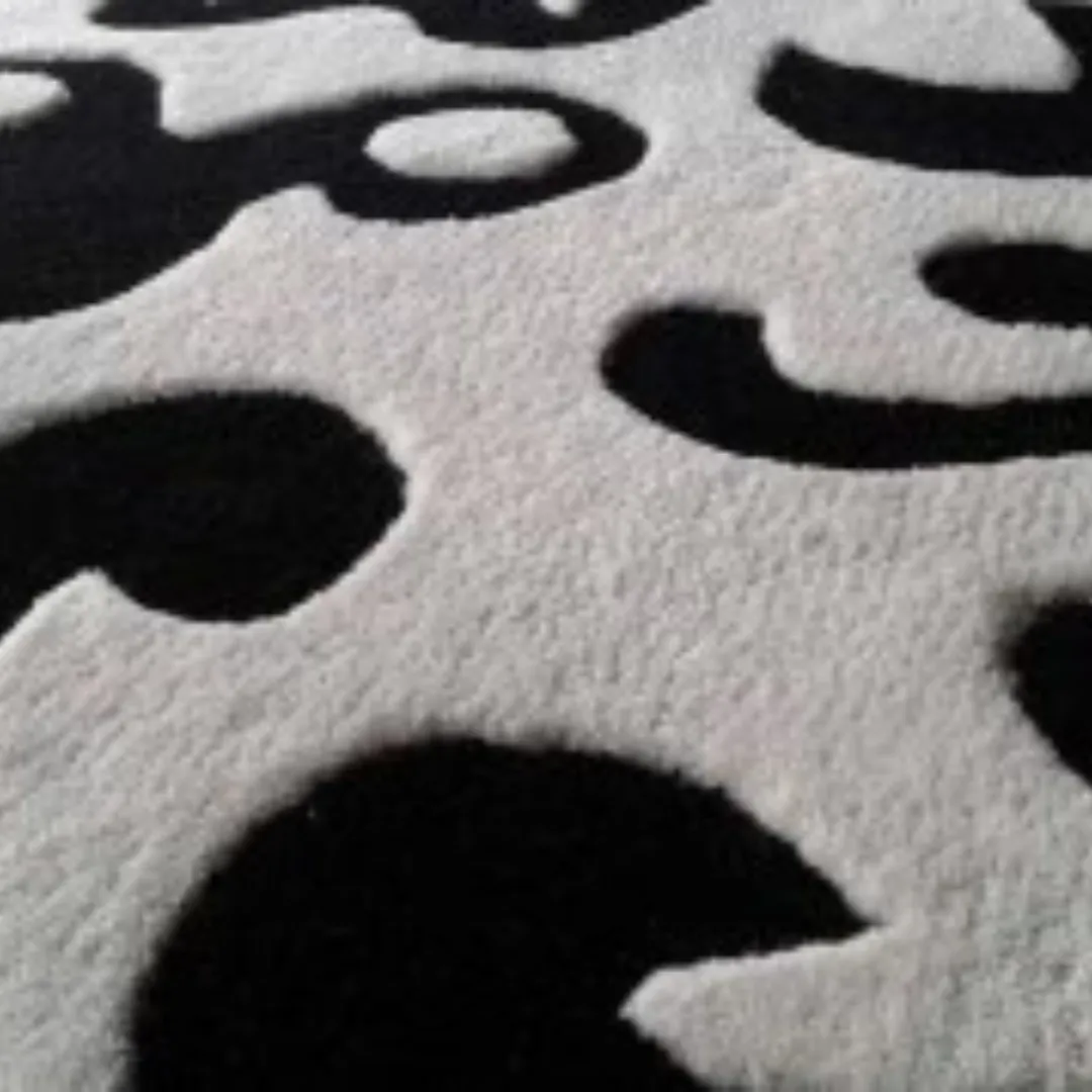 Black and white hand-tufted circular wool rug