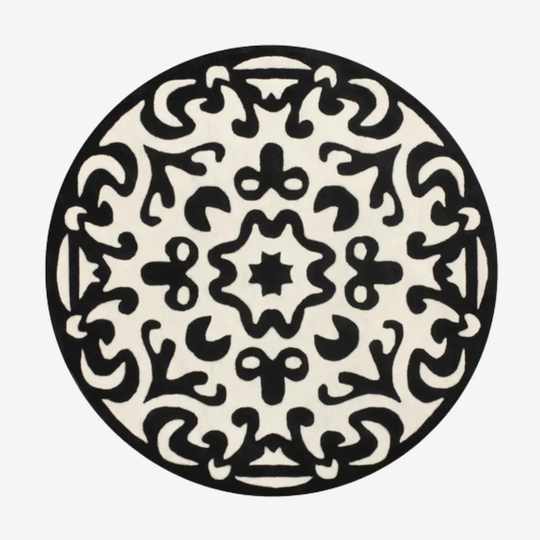 Round white wool rug with black ornate design