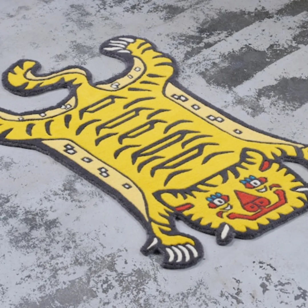 Yellow tiger rug in Tibetan-inspired shape with bold stripes on it
