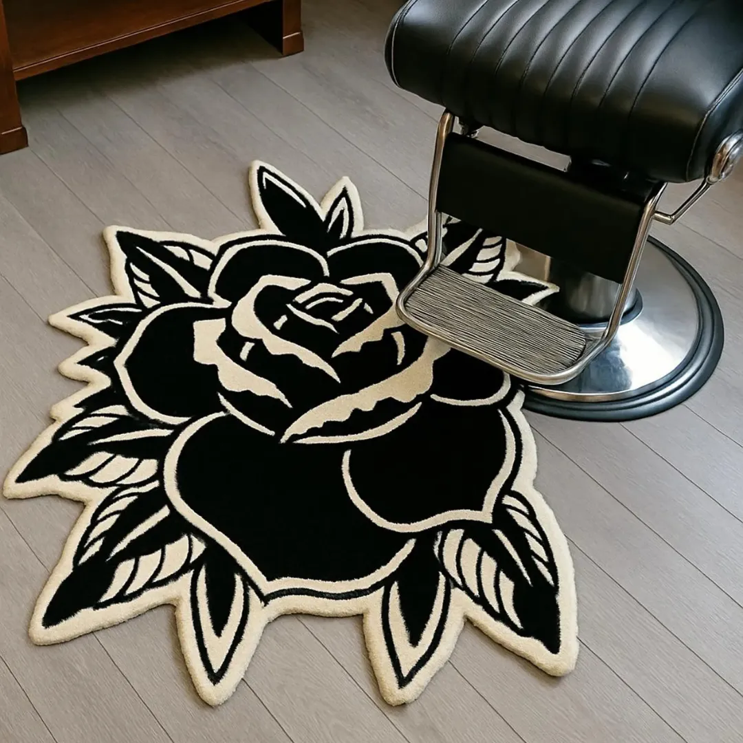 Large black rose with white accents and detailed leaves.