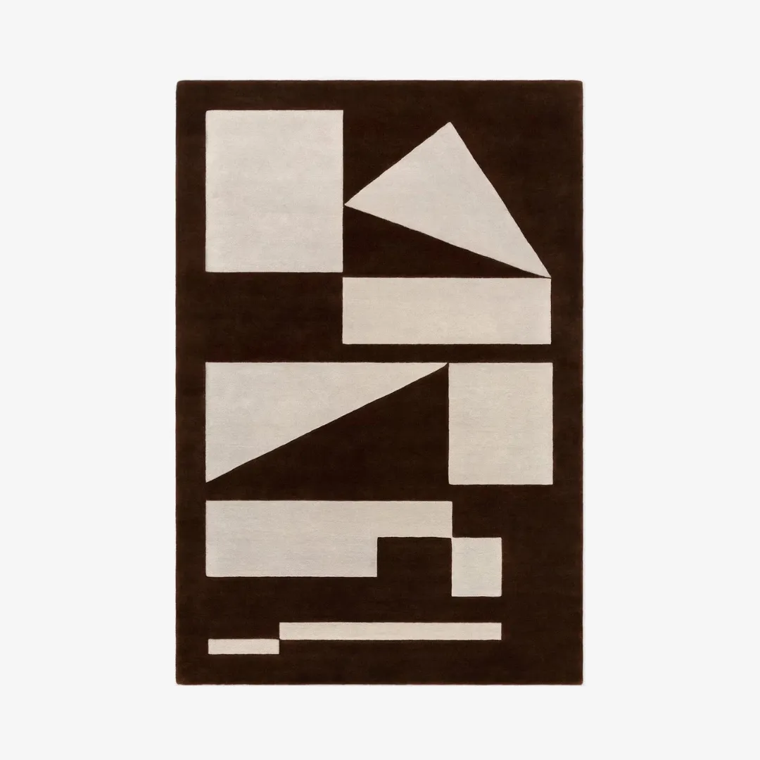 Modern geometric rug with bold brown and beige abstract shapes.