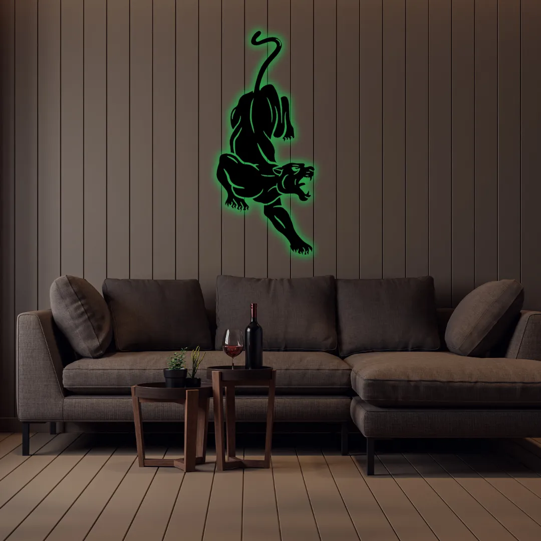 Green Leaping Panther Silhouette Leaping Panther metal wall art in black square frame above yellow sofa.