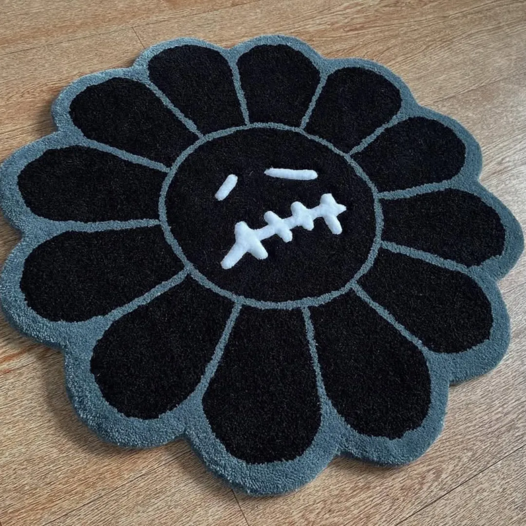 Noir Bloom Takashi Rug Monochrome Noir Bloom Rug crafted from premium wool, showcasing black petals with a grey outline and expressive stitched mouth motif.