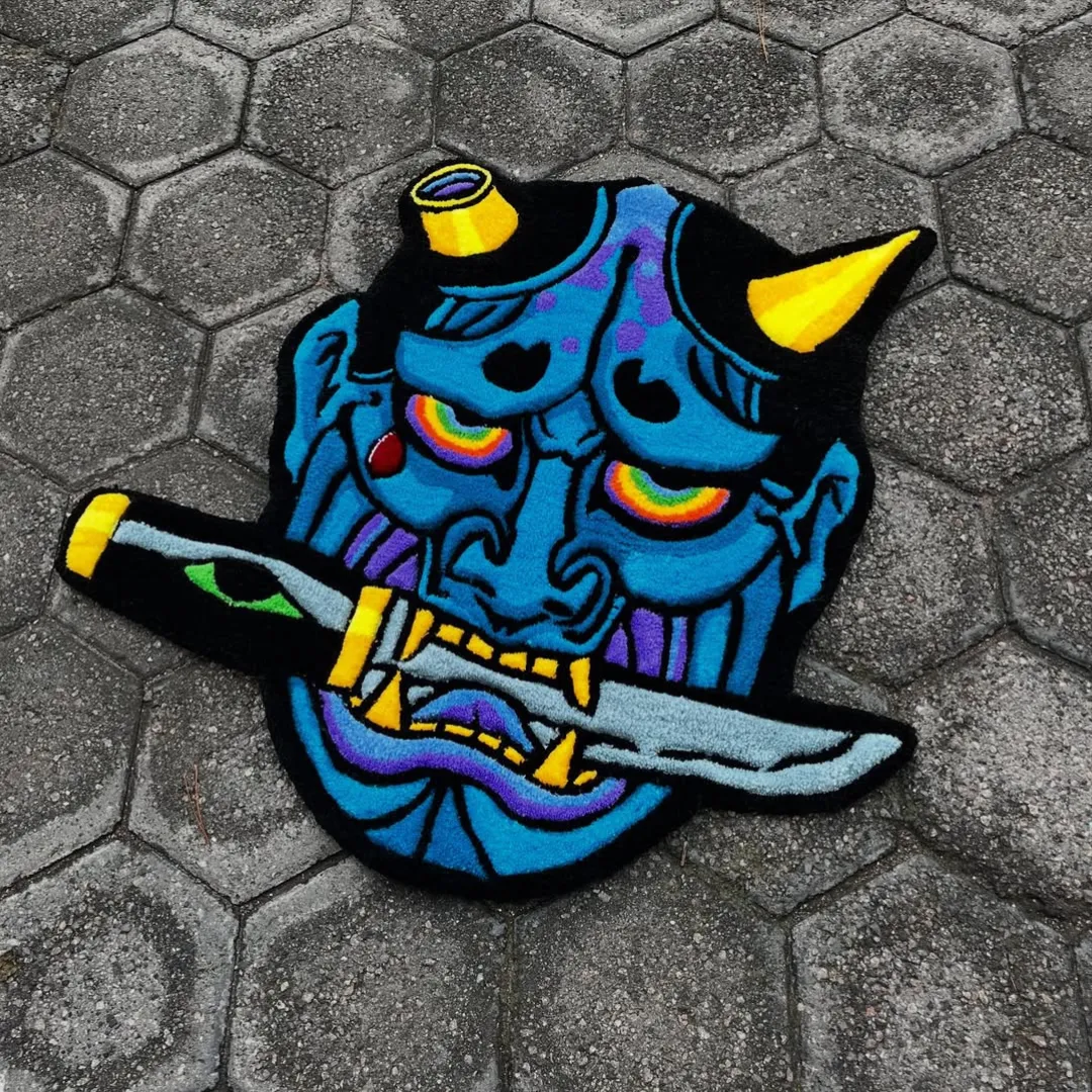 Oni Surge Rug Oni Surge Rug featuring vibrant blue demon face with yellow horns and sword design – handmade tufted rug
