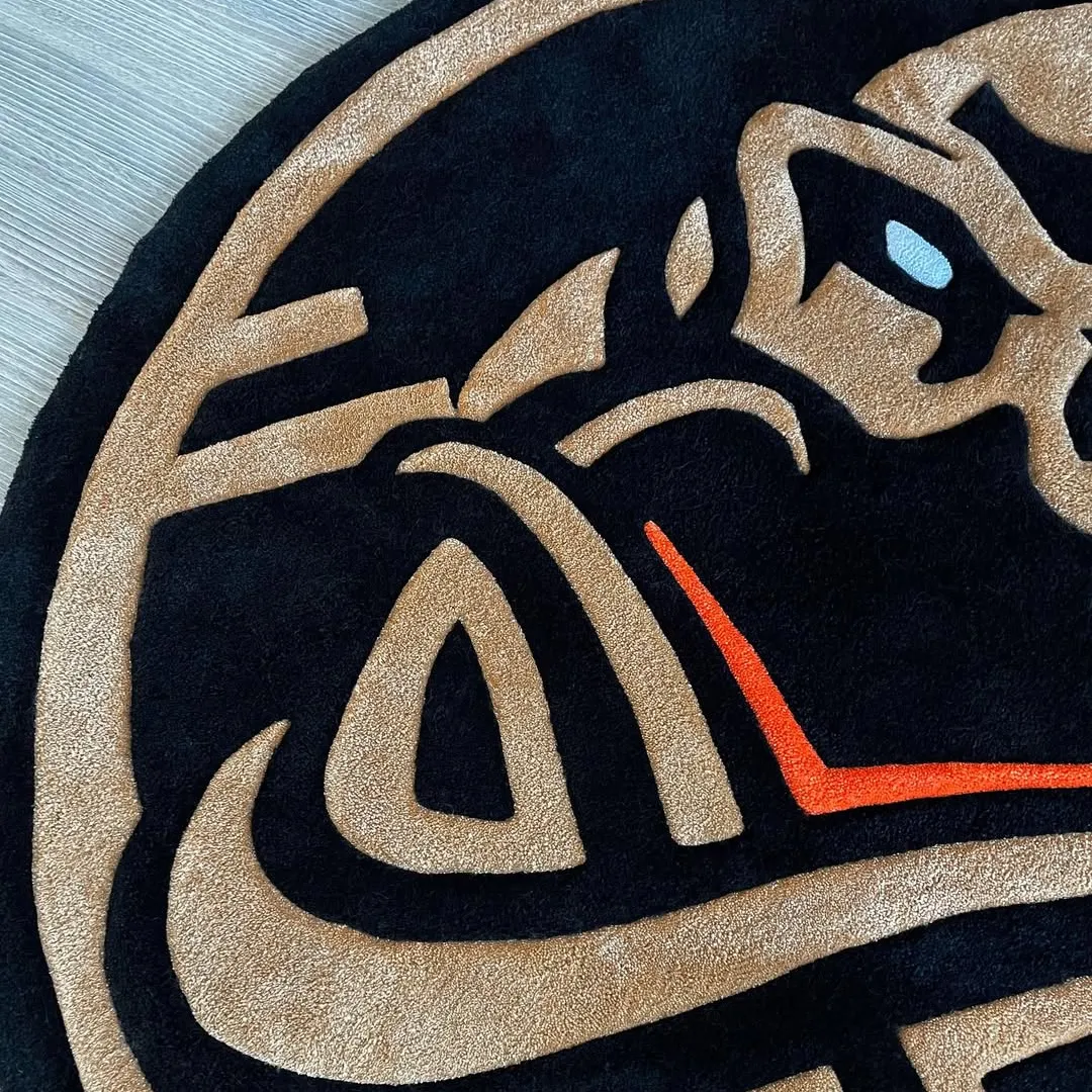 Vortex Rug Hand-tufted Obsidian Crest Rug showcasing artistic emblem design in gold and black tones