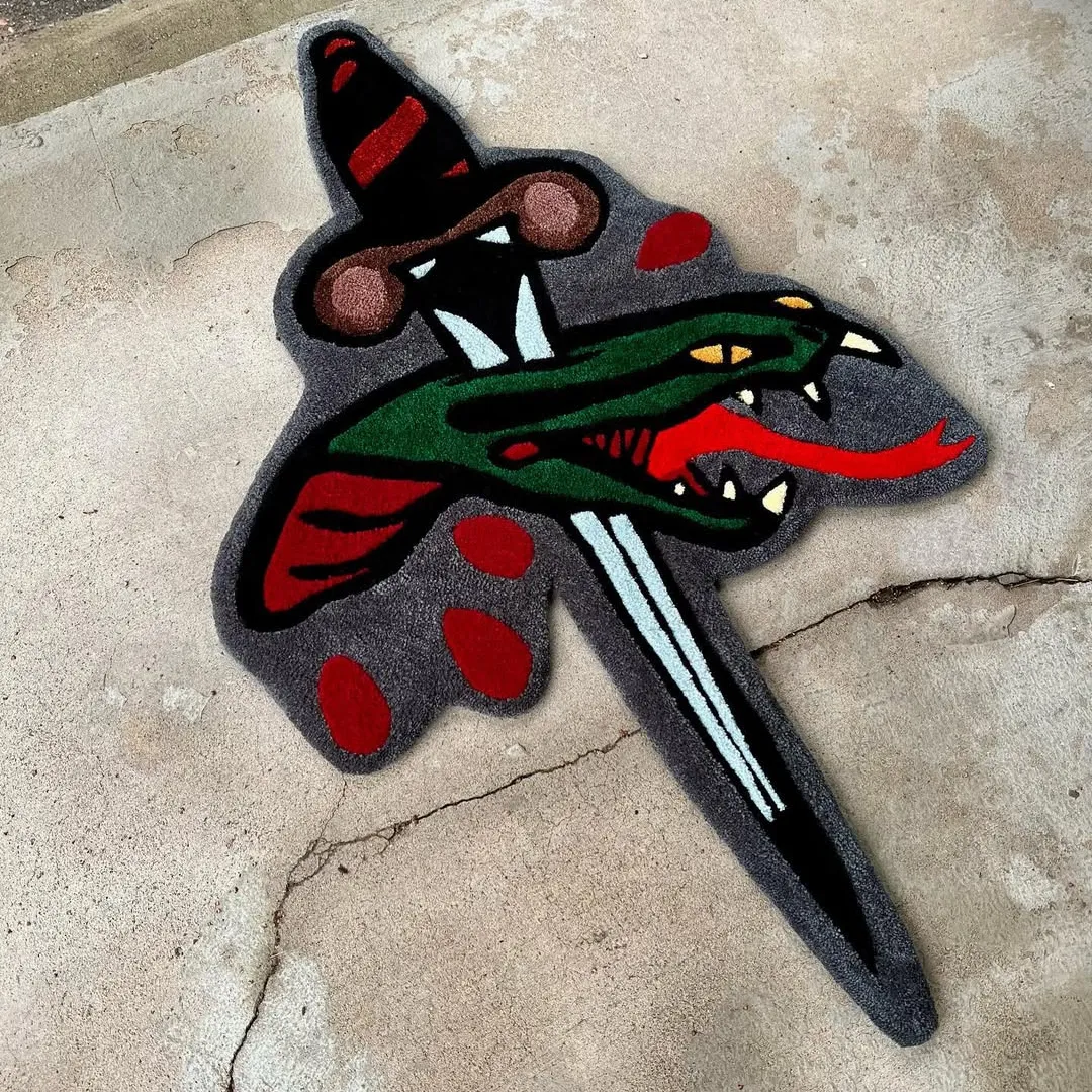 Viper Pierce Tattoo Rug Hand-tufted wool rug showcasing snake and dagger tattoo motif – Viper Pierce Rug by Sneagear