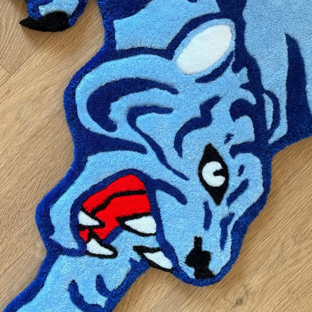 Cool Fang Rug Blue Tiger Head Detail Close up texture shot of the Cool Fang rug highlighting the tufted wool details of the blue tiger face and open red mouth.