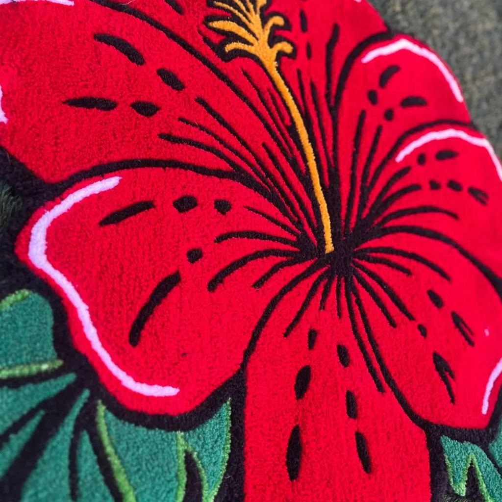 Ember Petal Hand Tufted Floral Rug Close Up Angled close up shot of the Ember Petal rug highlighting the plush cut pile and vivid red color of the floral design.