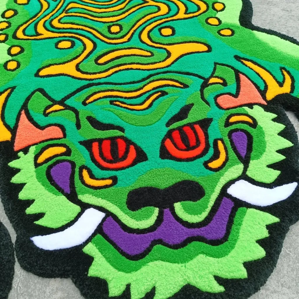 Moss Claw Rug Green Dragon Head Detail Close up texture shot of the Moss Claw rug highlighting the fierce green face with red eyes and purple mouth