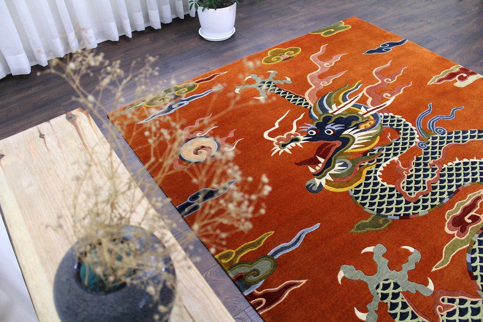 Ember Rise Rectangular Statement Floor Rug Side perspective view of the rectangular Ember Rise rug in a modern home setting, emphasizing the plush pile height and the vivid contrast of the blue dragon against the orange base.