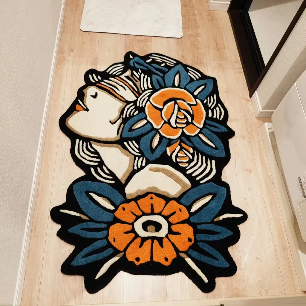 Lady Rose Flash Art Hand Tufted Rug High angle view of the Lady Rose Flash Art rug featuring a custom die cut shape and a traditional tattoo design of a woman profile with blue and orange flowers.