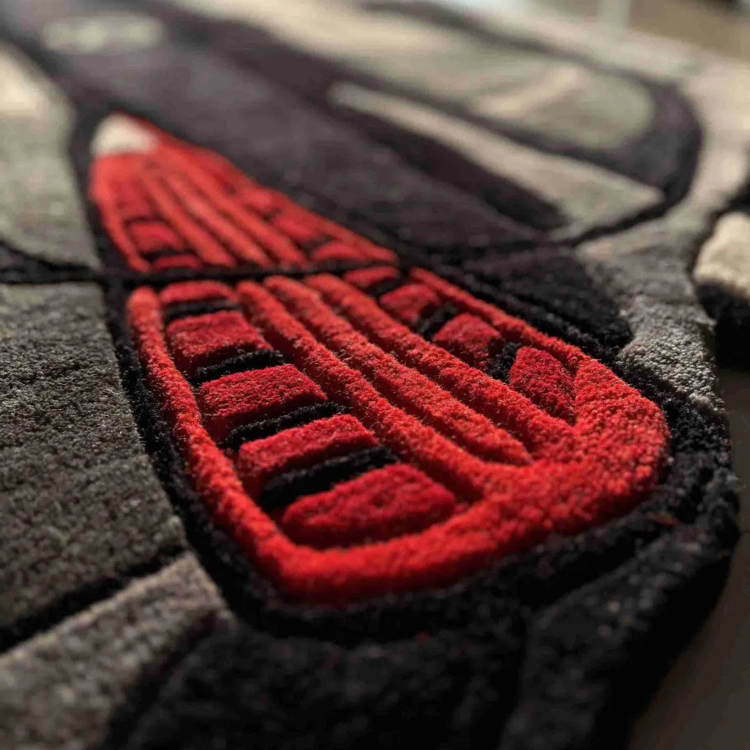 grand crest rug red taillight detail Close-up detail of the Grand Crest rug's red taillight, highlighting the thick plush wool texture and precise hand-carved 3D depth.