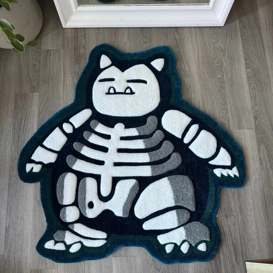 lazy lax skeleton anime rug Top down view of the Lazy Lax rug featuring a custom die-cut shape of a sleeping monster skeleton in deep teal and white hand-tufted wool.