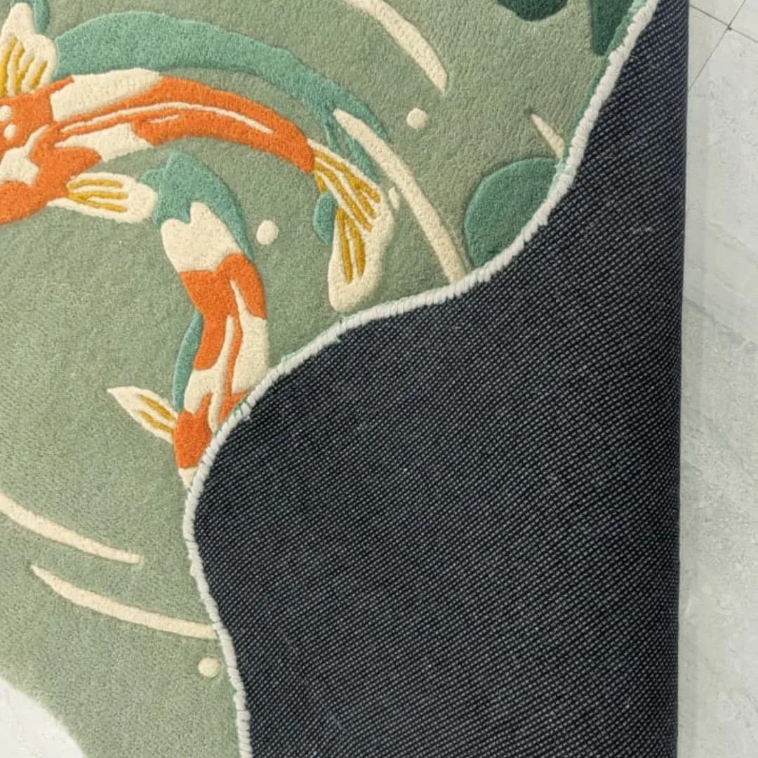 mizu garden rug backing detail View of the underside of the Mizu Garden rug revealing the durable canvas backing and high-quality hand-finished edges next to the soft green wool pile.