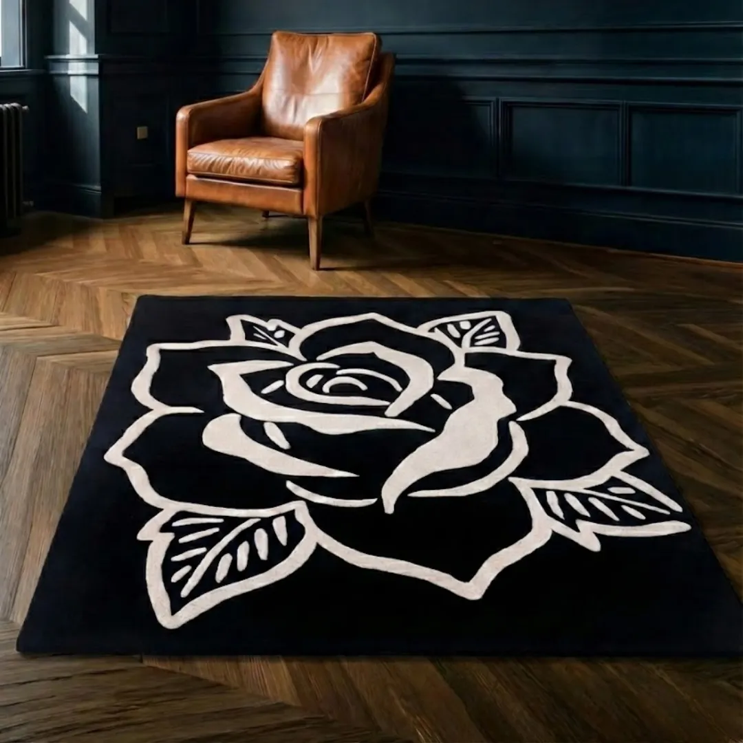 shadow rose rug wood floor styling The Shadow Rose rug placed on herringbone wood flooring near a leather armchair, highlighting the contrast between the dark rug and warm wood tones.