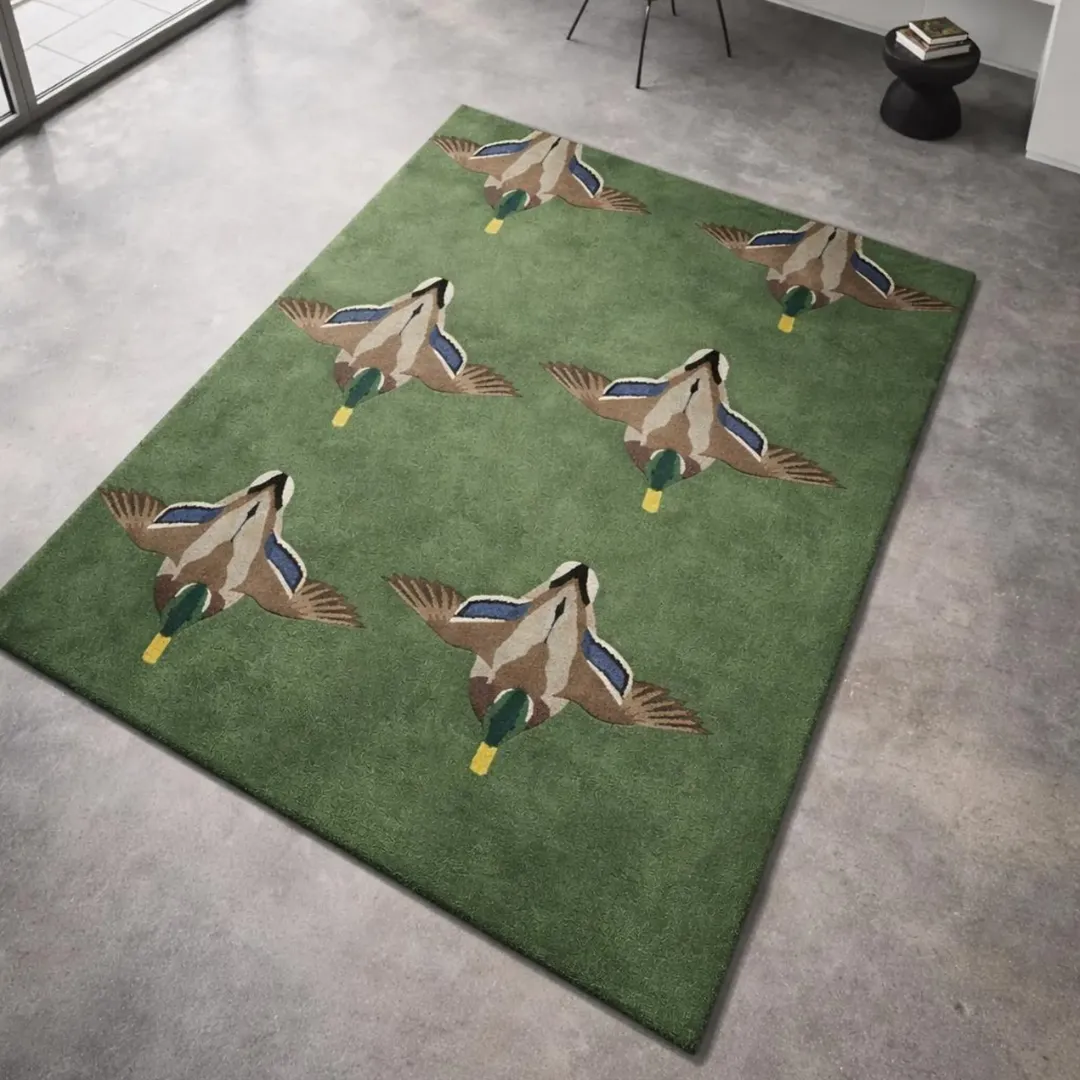 verdant flight mallard duck green rug The Verdant Flight rug styled in a modern home office, showing how the wildlife motif adds character and a nature-inspired touch to a minimalist workspace.