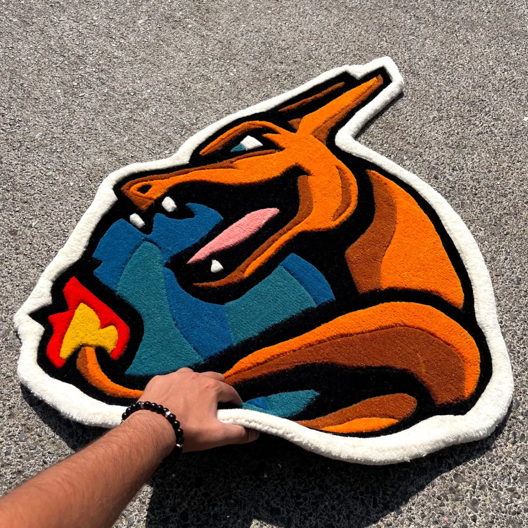 volcanic roar red dragon fire rug Close-up detail of the Volcanic Roar rug showing the thick hand-tufted wool texture around the yellow eye and the precise carving of the black outlines.