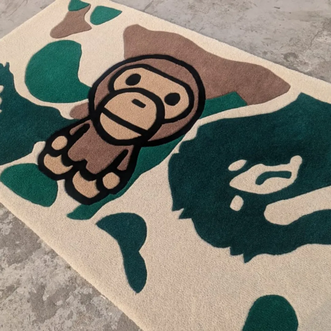 Angled view of the Camo Heritage rug on a raw concrete surface, highlighting the iconic streetwear-style ape character embedded within the bold green and brown camouflage shapes.