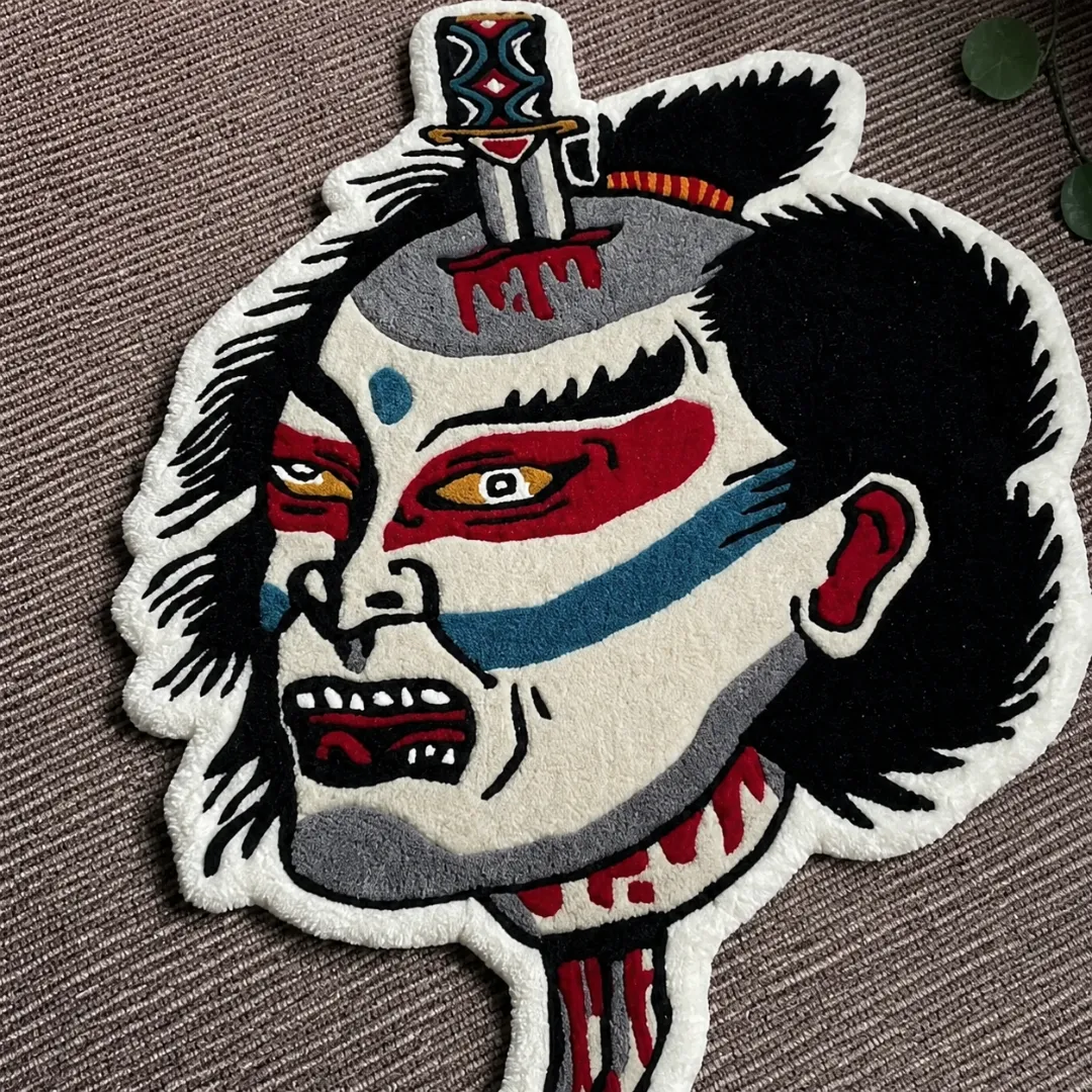 Close-up of the detailed tufted pile texture, striking red and blue face makeup, and intricate dagger motif on the Namakubi Design rug.