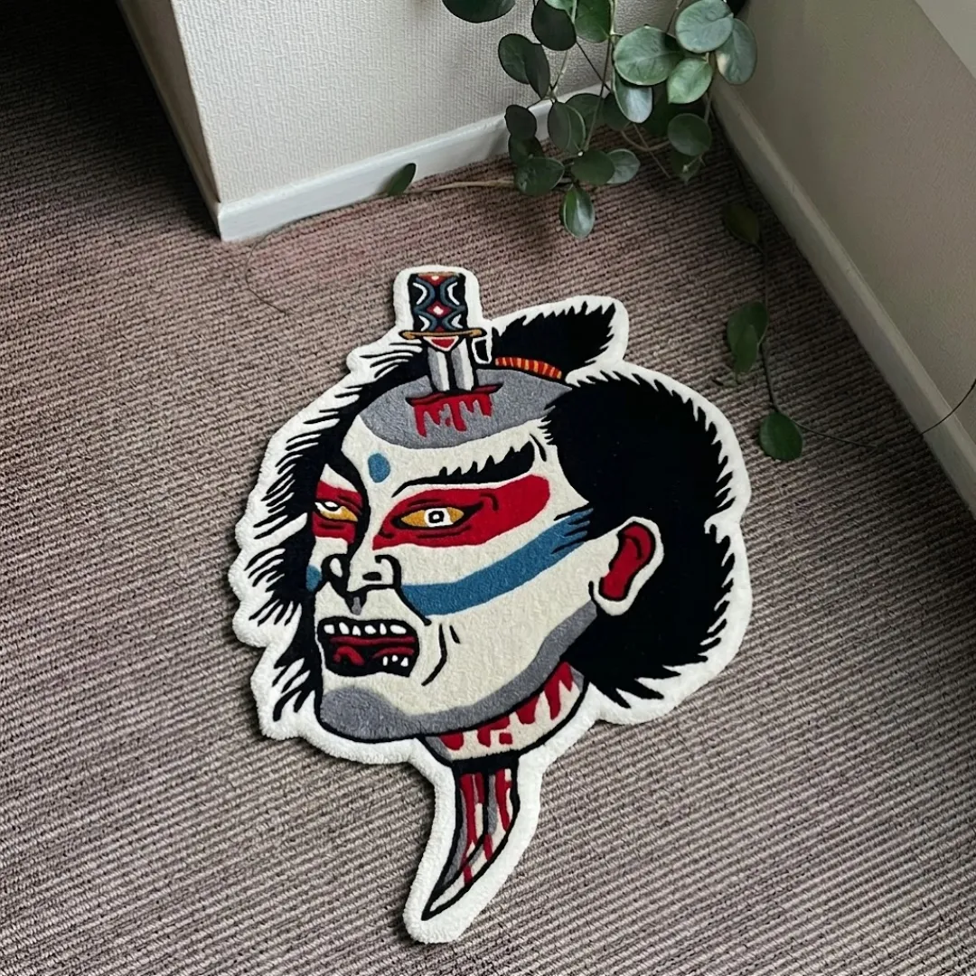 Namakubi Design traditional Japanese tattoo style severed head shaped tufted area rug displayed flat on a textured carpeted floor.