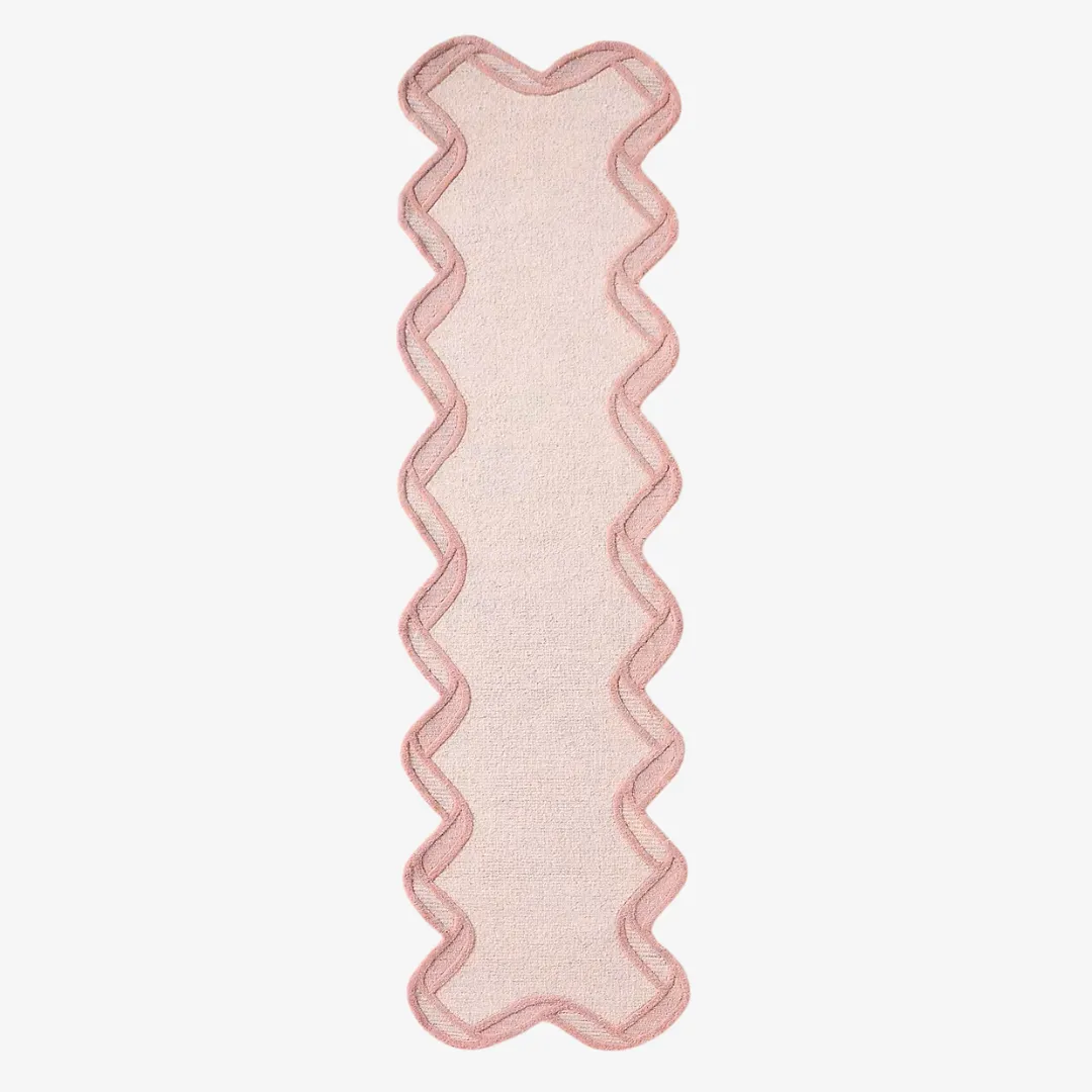 Top view of hand tufted pink rug with elegant scalloped frame