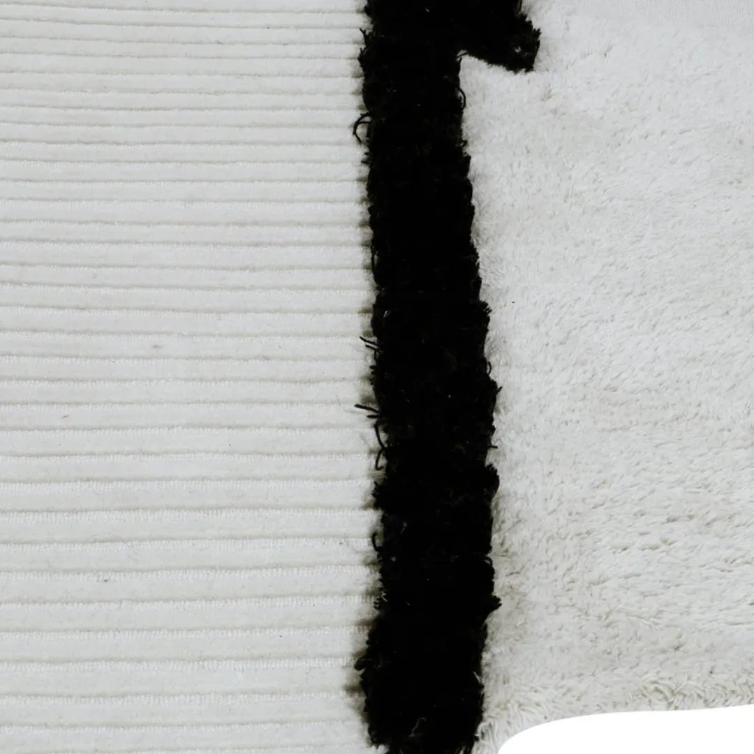 Zen-inspired black and ivory rug with ribbed and shag textures