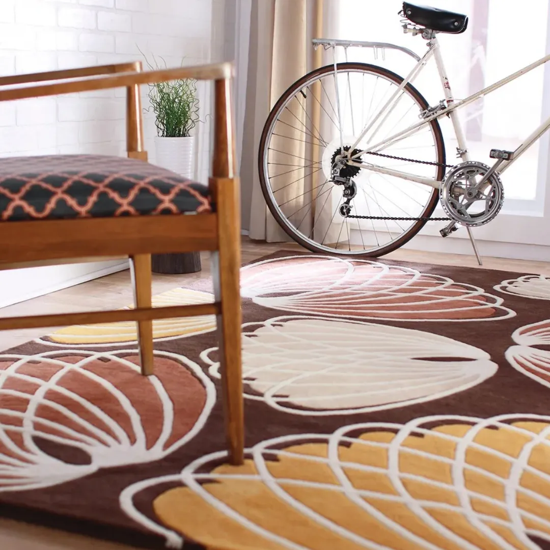Soft wool rug with modern leaf patterns in brown and orange