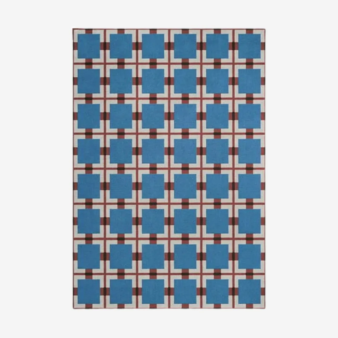 Hand-tufted geometric blue wool area rug with blue squares and red checkered base inspired by Bauhaus style