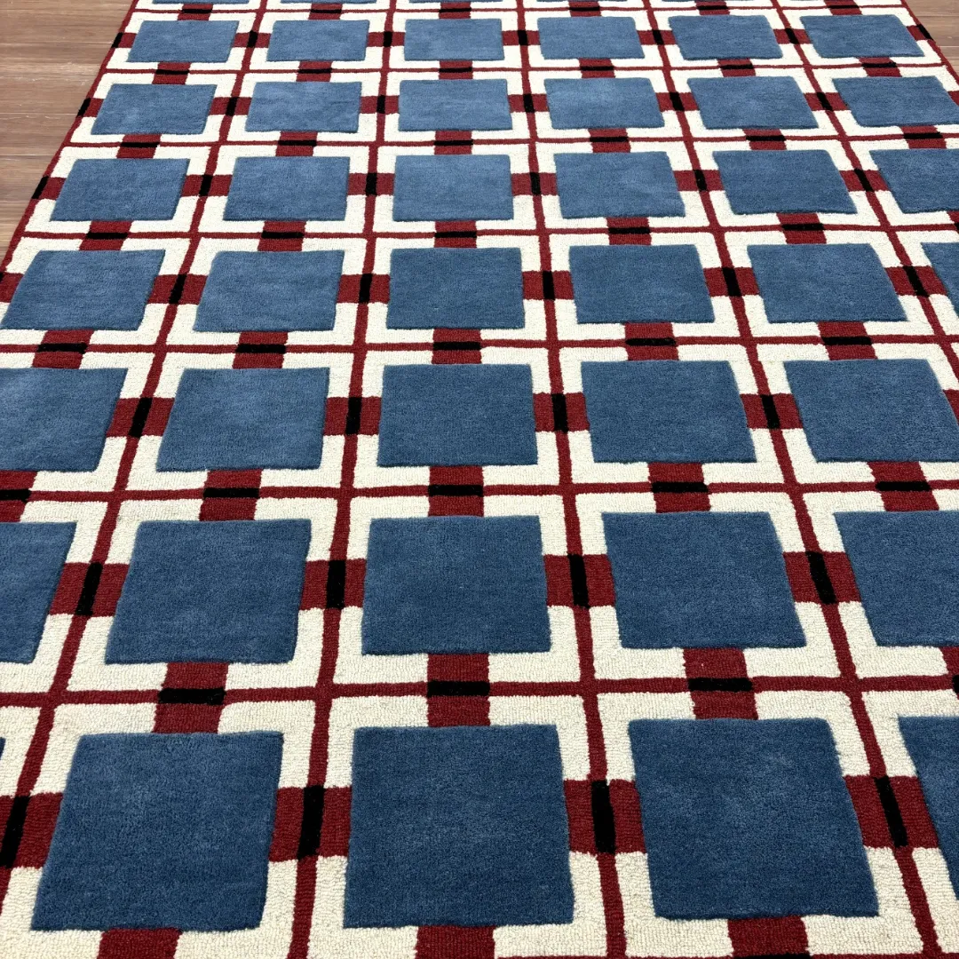 Hand-tufted geometric wool rug with blue squares and red checkered base inspired by Bauhaus style
