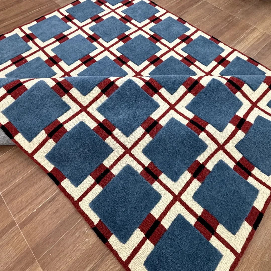 Hand-tufted geometric wool rug with blue squares and red checkered base
