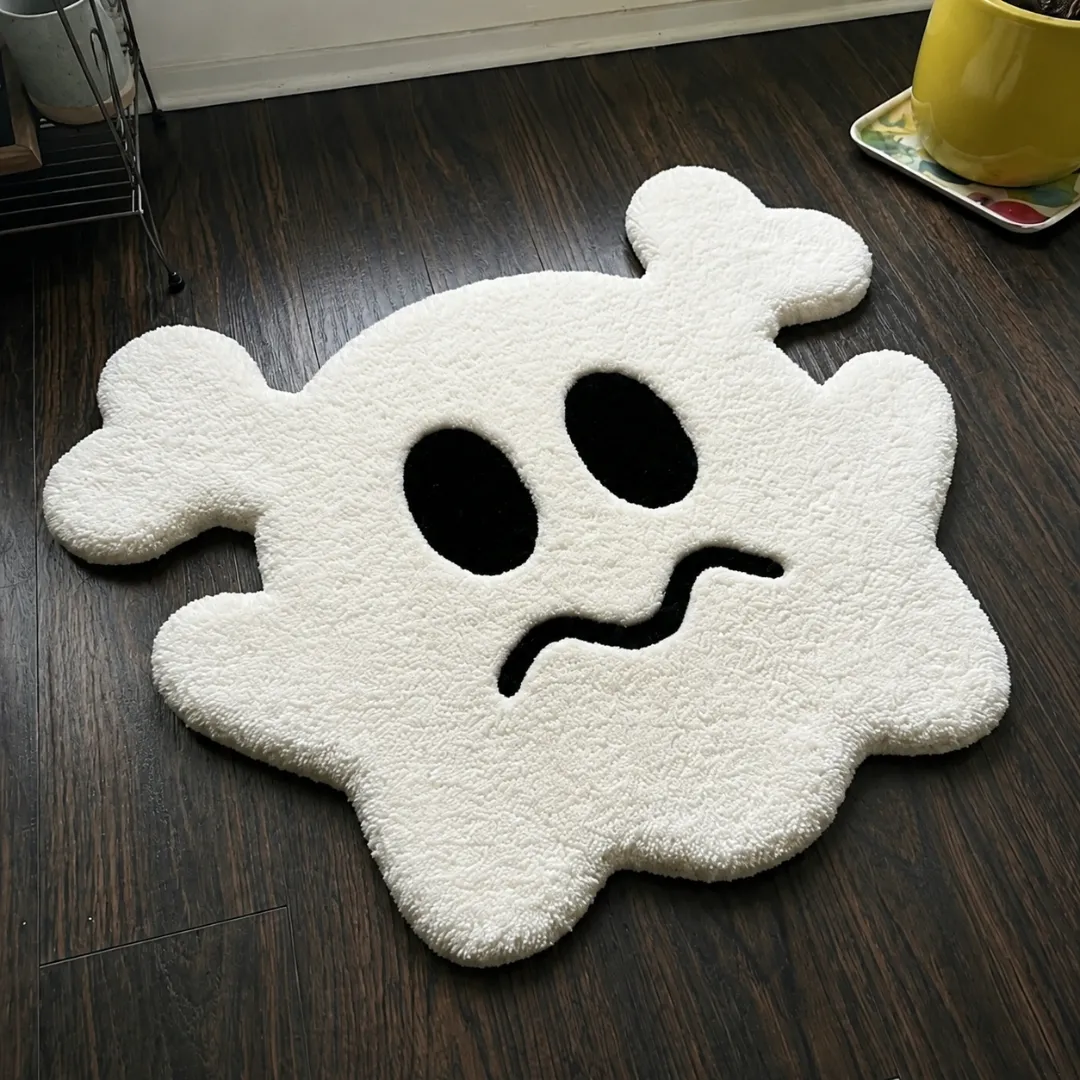 gravine emblem rug angle view Angle view of the handmade Gravine Emblem tufted rug showcasing its playful ghost silhouette and plush white texture.
