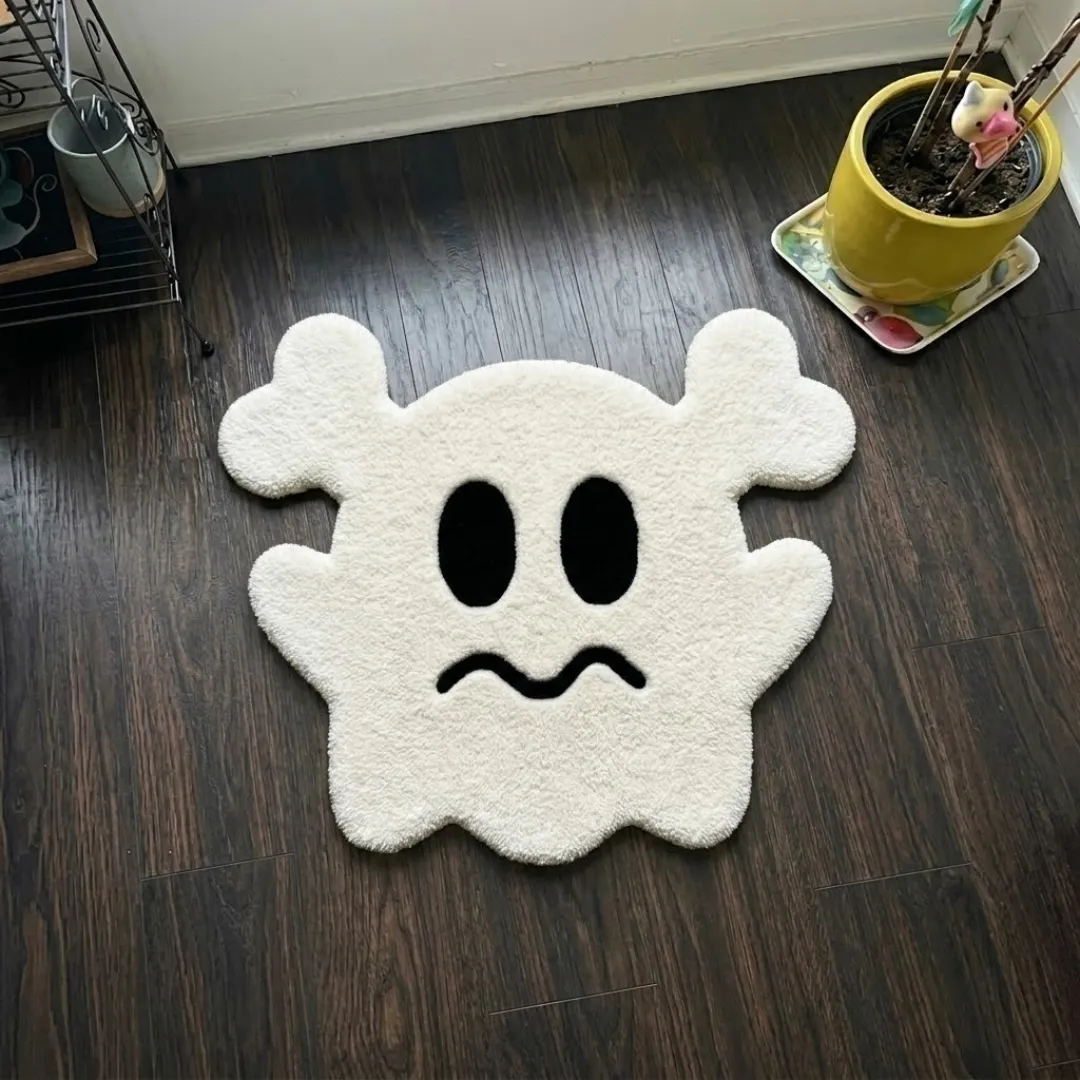 gravine emblem rug top view Gravine Emblem quirky ghost shaped tufted area rug displayed flat on a dark wooden floor.