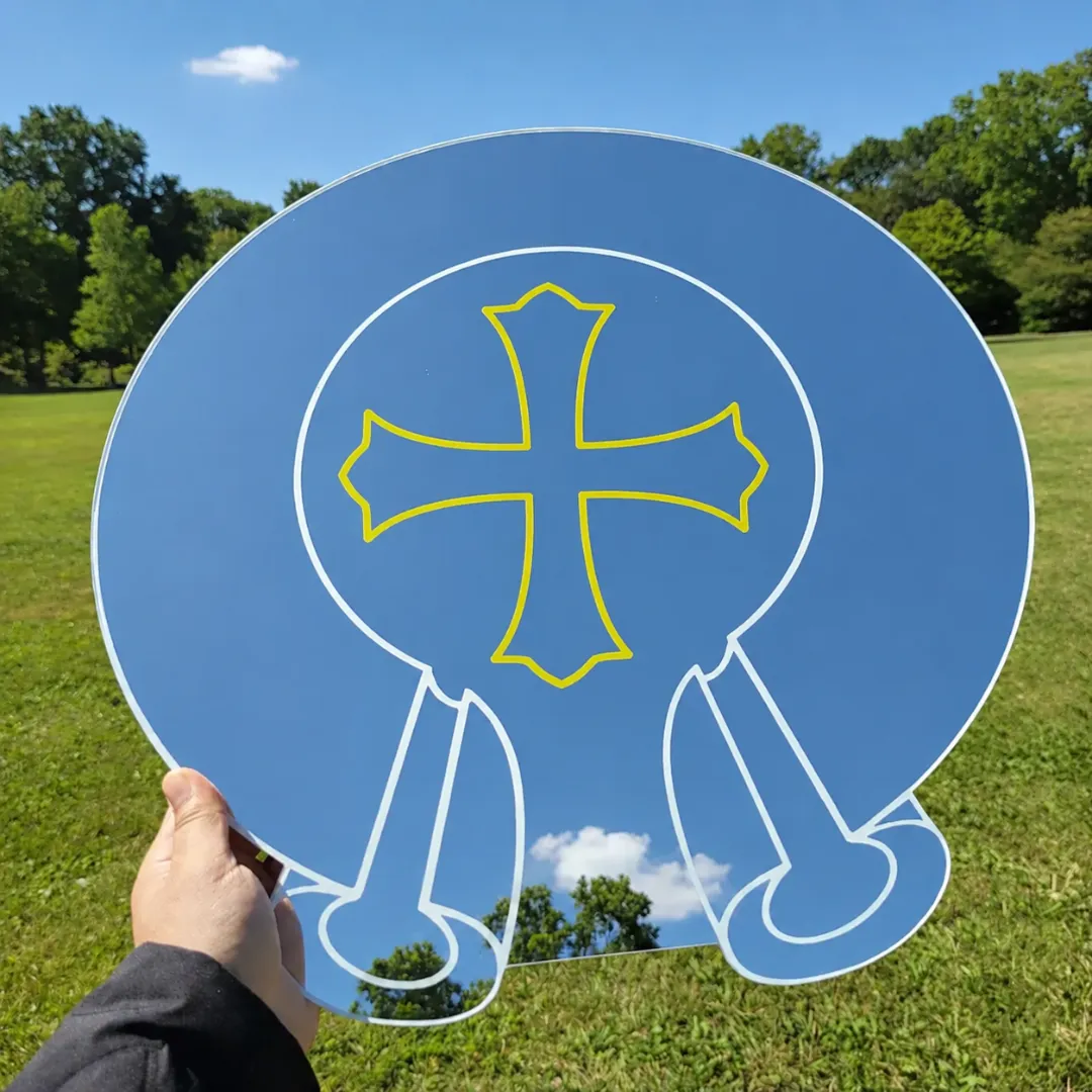 modern gothic cross mirror grass flat pic Round modern gothic cross mirror with multicolor typography placed on grass flat lay outdoor decor