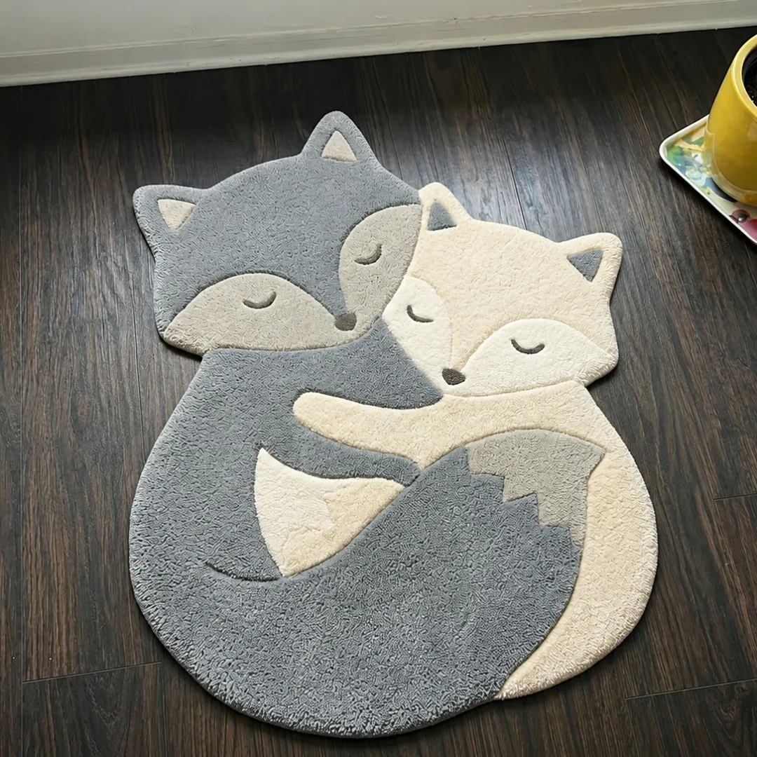 nova cuddle rug top view Nova Cuddle cuddling foxes shaped tufted area rug displayed flat on a dark wooden floor.