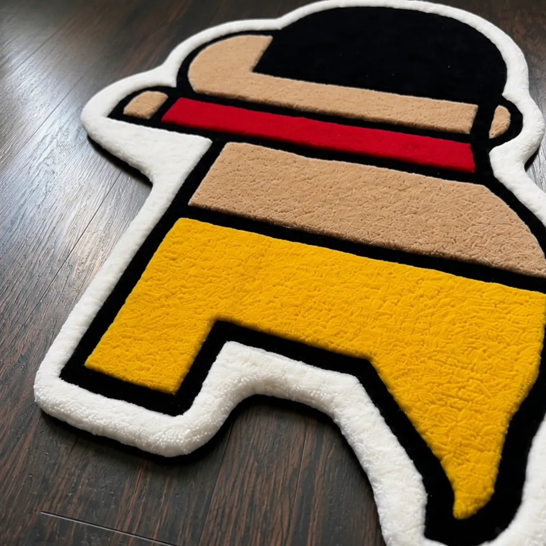 tiny trouble rug close up texture Close-up of the detailed tufted pile texture, clean black outlines, and yellow and red design on the Tiny Trouble rug.