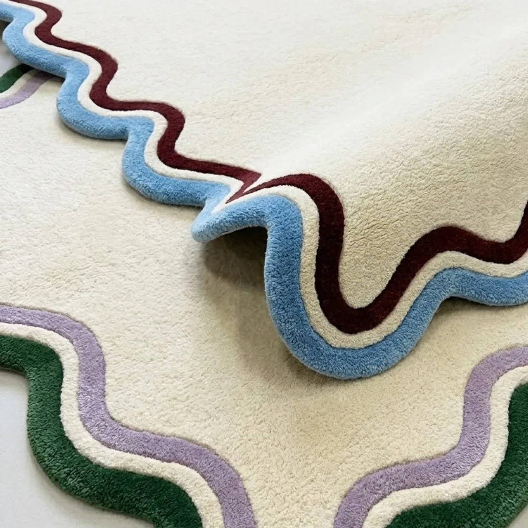 serena scalloped edge rug folded texture detail A macro view of the Serena rug folded over, highlighting the high-quality tufted wool construction and the layered colored border design.