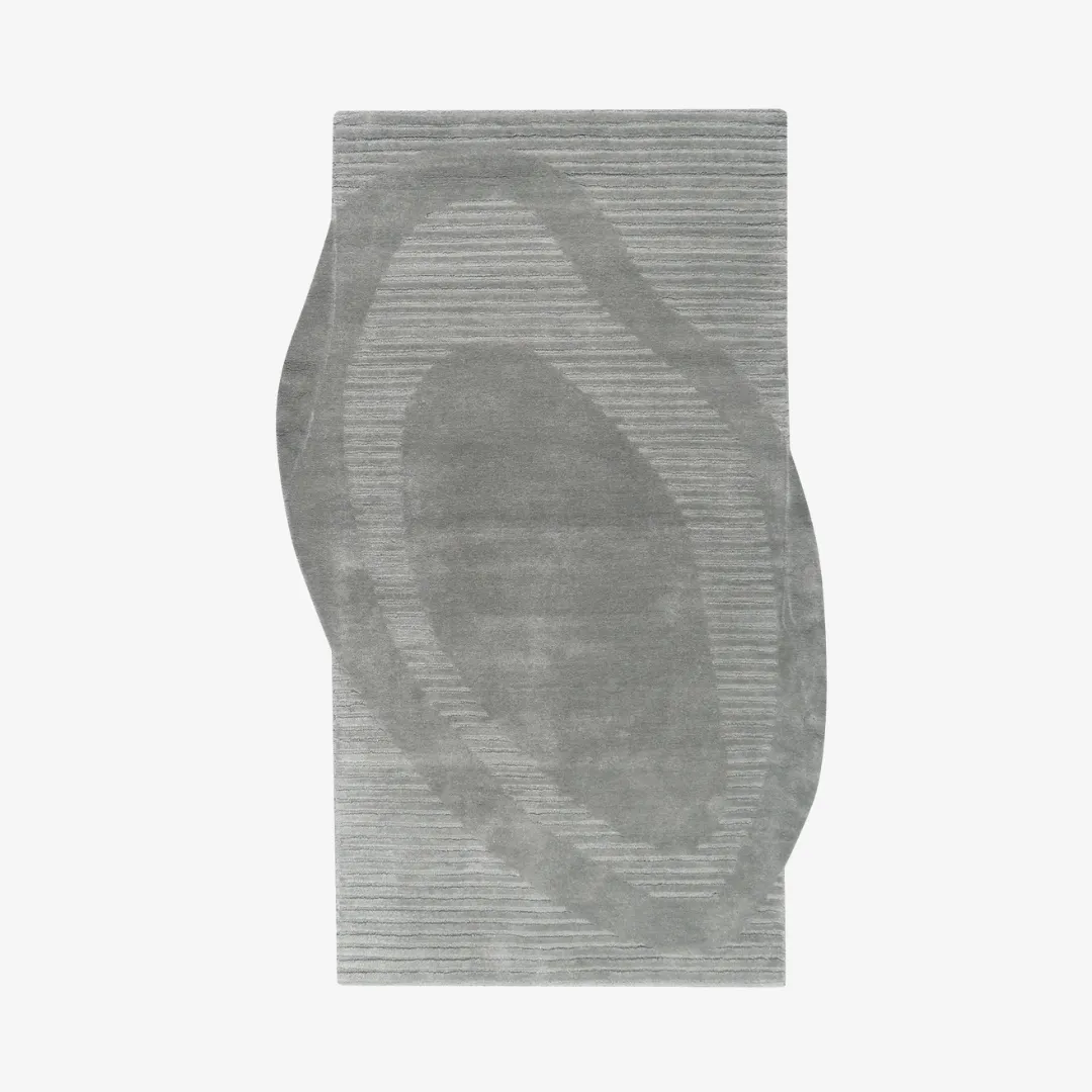 Sculpted gray area rug with abstract wave design