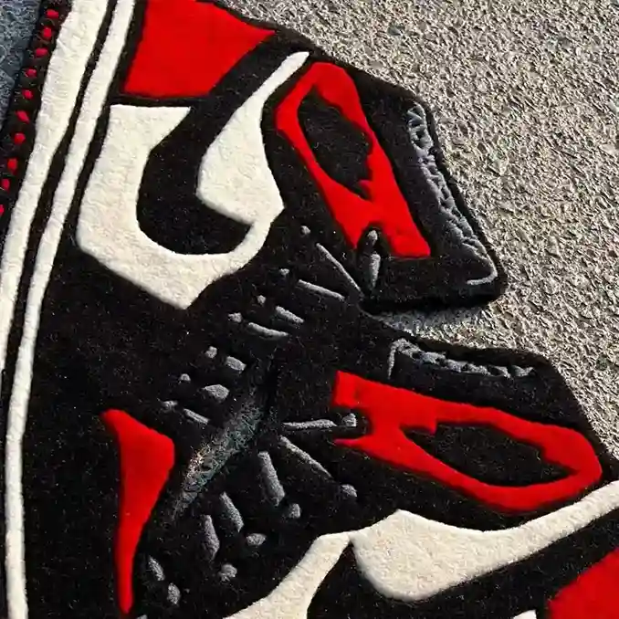 Hanging sneaker rug with black, red, and white colorway