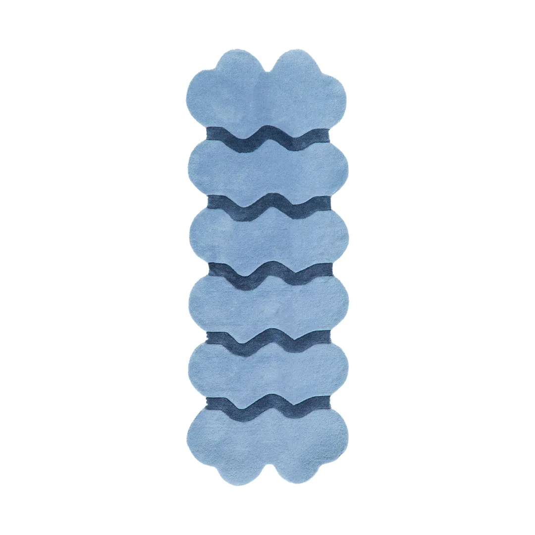Wavy solid blue hand-tufted kitchen runner rug made of wool, styled in a modern galley kitchen.