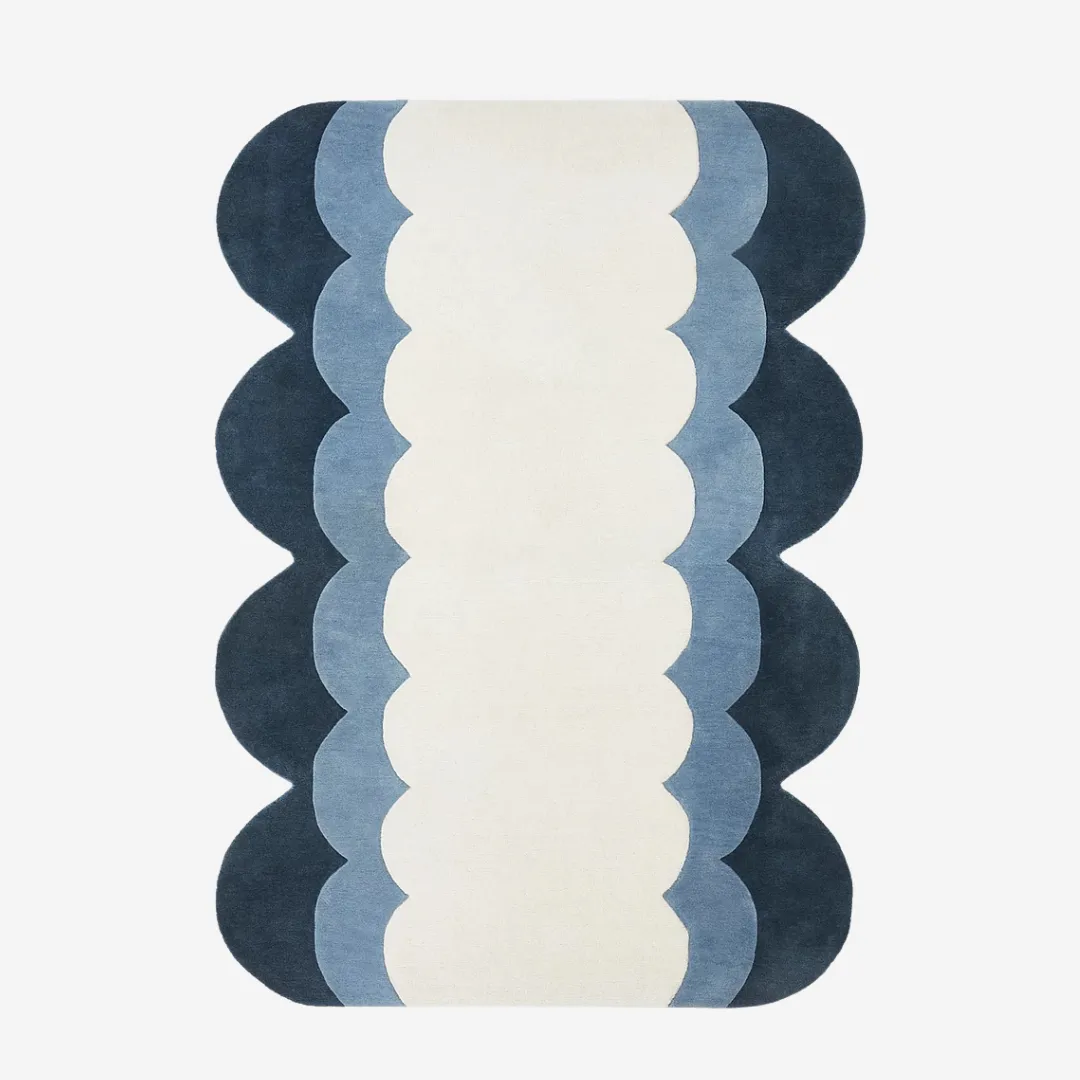 Ocean-inspired runner rug with scalloped edge in blue tones